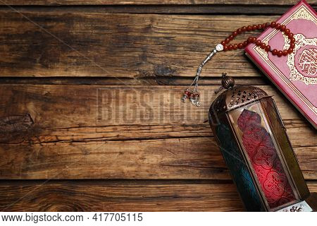 Arabic Lantern, Quran And Misbaha On Wooden Table, Flat Lay. Space For Text