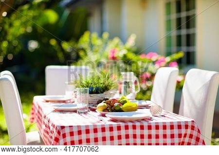 Summer Lunch Outdoors. Table Setting For Barbecue Party. Garden Fun. Bbq In Sunny Backyard. Party De