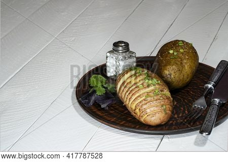 Baked Potatoes In The Skin On A Plate