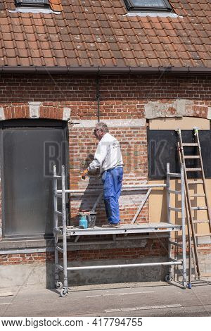 Sint Gillis Waas, Belgium, 21 April 2021, Elderly Craftsman Who Practices As A Painter Prepares The 