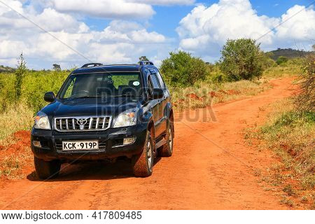 Taita Hills, Kenya - February 3, 2021: Black Offroad Car Toyota Land Cruiser Prado 120 At The Red Cl