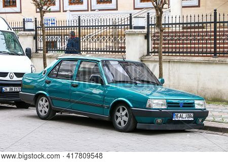 Istanbul, Turkey - February 11, 2021: Green Saloon Car Tofas Dogan In The City Street.
