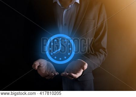 Businessman Hand Holds The Icon Of Hours Clock With Arrow. Rapid Execution Of The Work.business Time