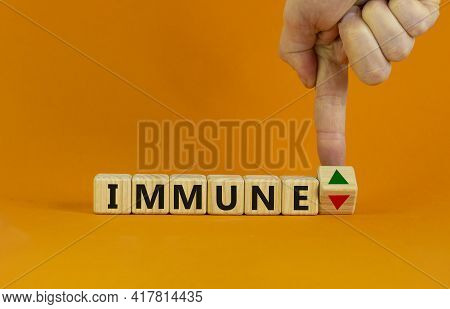 Corona Immune And Medical Symbol. Doctor Turns A Cube And Changes The Expression 'immune Down' To 'i