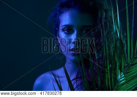 Fashion Portrait Of Atrractive Woman With Modern Green Leaf Accssesoies In Professional Studion With