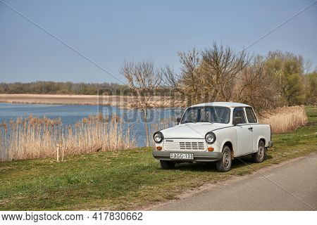 Tiszafured, Hungary - Circa 2021: Trabant, old east german comminist cheap compact car parked on the lakeside