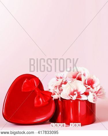 Heart Shape Gift Box And Bouquet On Pink Background.