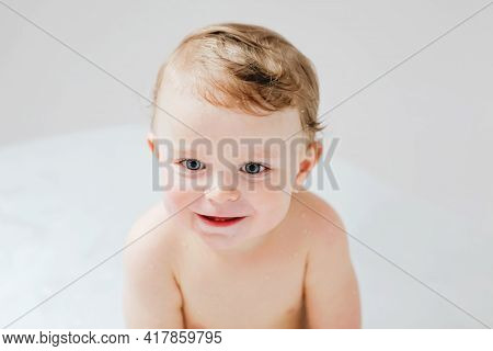 Cute Adorable Baby Child Taking Bath In Bathtub At Home. Happy Healthy Boy Or Girl Playing, Splashin