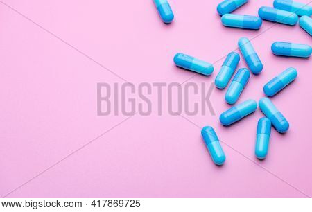 Blue Capsule Pills On Pink Background. Blue Capsule Pills With Copy Space. Pharmaceutical Industry. 