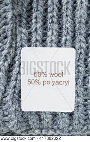 Fabric Composition Clothing Label On Blue Knitted Background