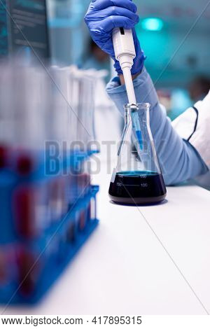Close Up Of Micropipette Dipping In Test Tube