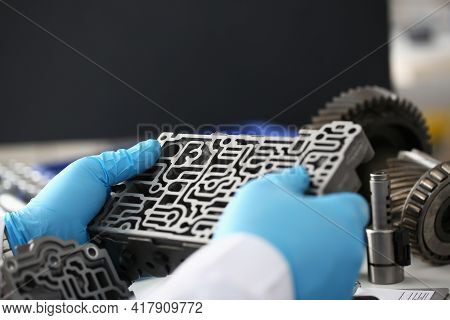 Man In Gloves Holds Car Gearbox Closeup