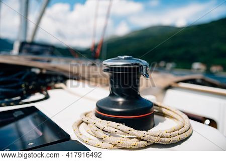 Black Halyard Winch With A Variegated Cable Against The Backdrop Of A Mountain Landscape