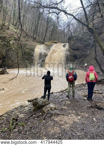 Guamka, Russia April 17, 2021: Beautiful Landscape Of Powerful Muddy Waterfall In Mountainous Terrai