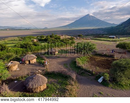 Aerial Drone Shot. Traditional Masai Village At Sunset Time Near Arusha, Tanzania
