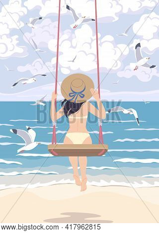 Young Woman In Straw Hat Swinging On Swing At The Sea Coast. Girl In Swimsuit Back View. Vacation Co