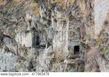 Ancient Dwellings In The Mountains. Kurtat Gorge In North Ossetia-alania, Russia. Stone Cave Houses 