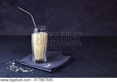 Rice In A Glass With A Metal Tube For Drinks. The Concept Of Plant-based Vegan Milk.