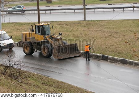 Its A Clean City. People, Workers Clean The Roads. Roadworks And Road Cleaning. High Quality Photo