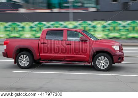 Moscow, Russia - April 2021: Fast Moving Red Off-road Vehicle Toyota Tundra. Overspeed In City Conce