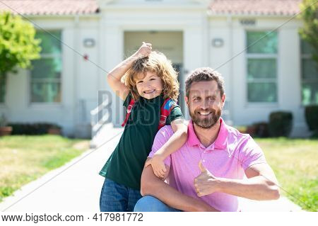 Father Walking Son To School. Parent And Pupil Schoolboy With Thumbs Up Sign. Happy Face.