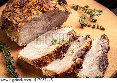 Roasted Shoulder On A Cutting Board, Roasted Christmas Ham Of Turkey. Large Piece Of Baked Pork With