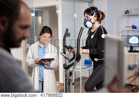 Doctor Scientist Holding Tablet Pc And Controling Ekg Data