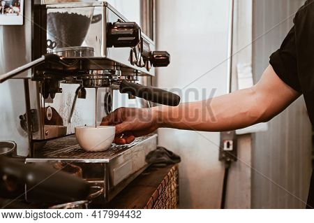View Of Barista Hand Using Espresso Machine To Making Espresso Coffee Shot. The Espresso Machine Is 