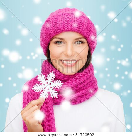 winter, people, happiness concept - woman in hat and muffler with big snowflake
