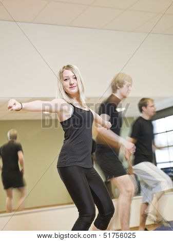 Group of people doing step up with a girl in focus
