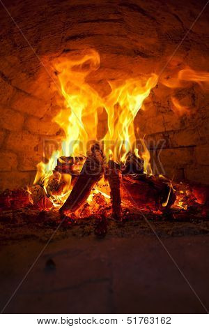Flaming Bonfire in front of brick wall