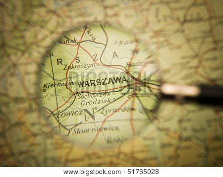 Magnifying Glass in front of a Warzawa map