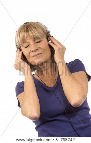 Senior Woman 50-60Years Listening To Music With Stereo Headphones On White.