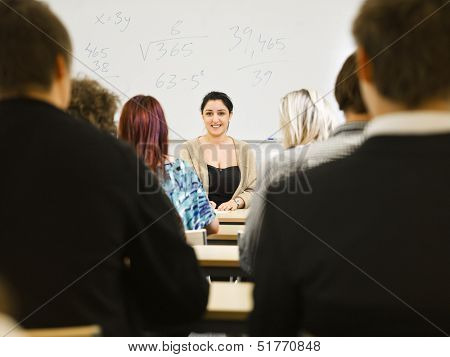 Schoolteacher in front of pupils in the classroom