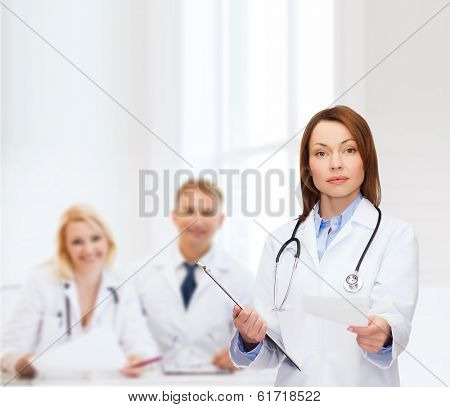healthcare and medicine concept - calm female doctor with clipboard and stethoscope