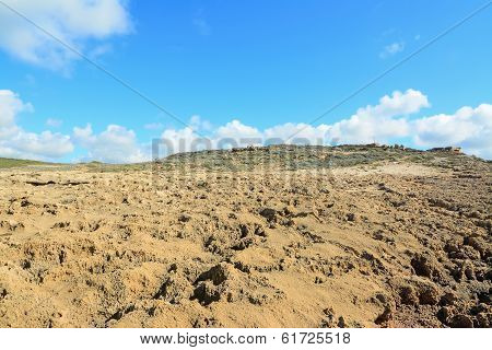 Clouds Over A Rocky Hill
