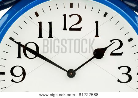 a blue alarm clock on white background. a wake white dial