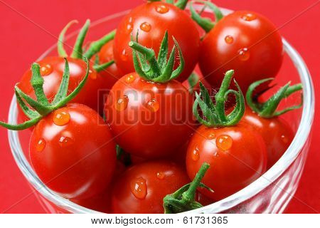 cherry tomatoes in glass bowl isolated on red background, lycopene image