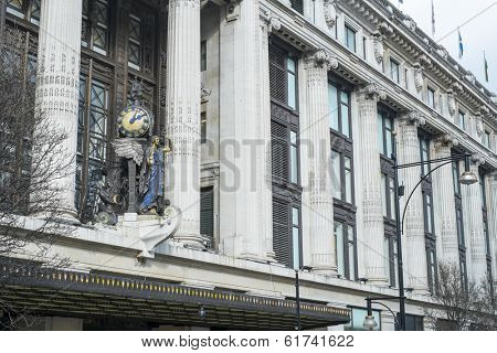 LONDON, UK - MARCH 01: Facade of famous department store Selfridges, with statue of angel holding clock. March 01, 2014 in London.