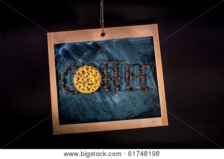 Word Coffee Written With Coffee Beans And Oatcake On Chalkboard