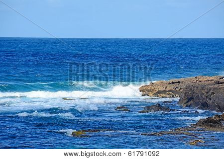 Rough Sea And Brown Rocks