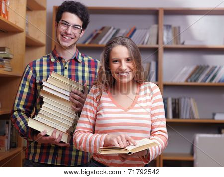 happy young teens group in school on chemisty lessons and library education