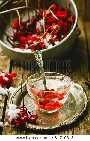 Fresh Berries Of A Guelder-rose In A Glass Cup On A Wooden Table.