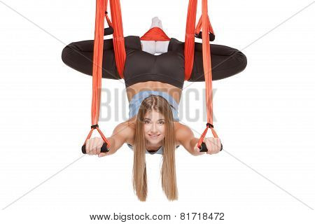 Young woman making antigravity yoga exercises in stretching twine
