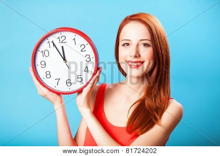 Redhead Girl With Huge Clock On Blue Background.