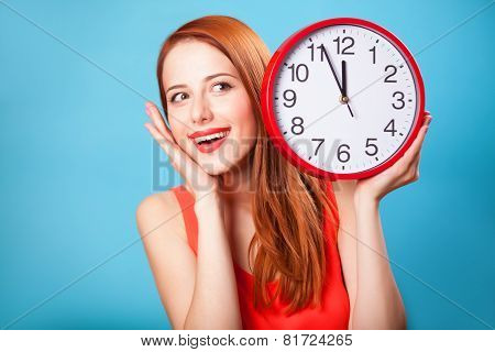 Redhead Girl With Huge Clock On Blue Background.