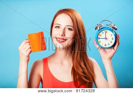 Redhead Girl With Tea Cup And Huge Clock On Blue Background.