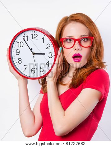 Surprised Redhead Girl With Huge Alarm Clock On Light Background.