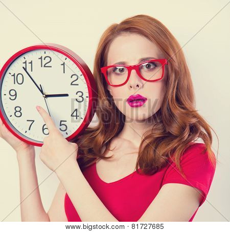 Surprised Redhead Girl With Huge Alarm Clock On Light Background.