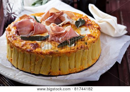 Pasta pie with cheese sauce and sage